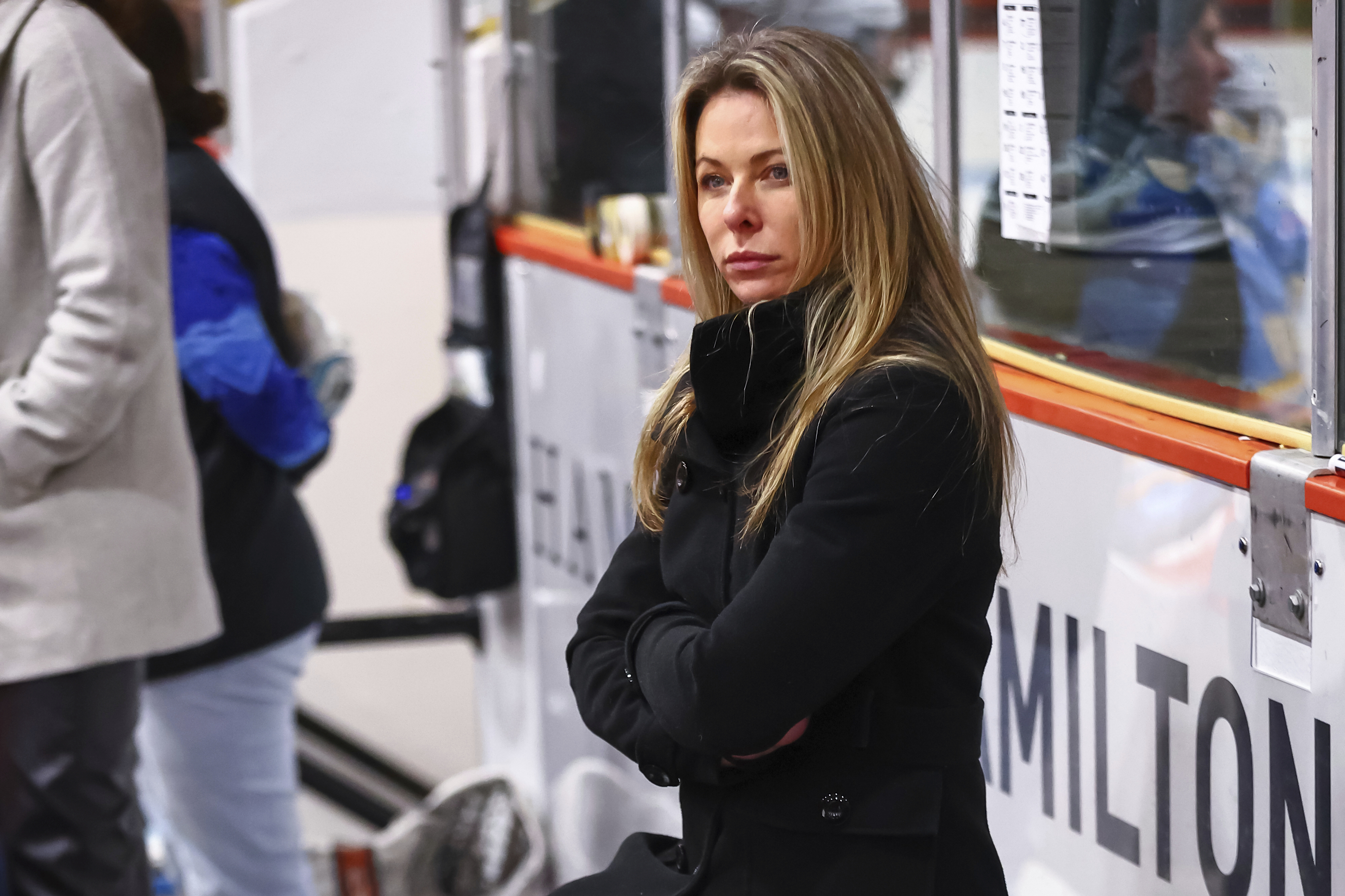 In this image provided by Princeton Athletics, Princeton women's hockey coach Cara Gardner Morey stands at the bench during a hockey game. 