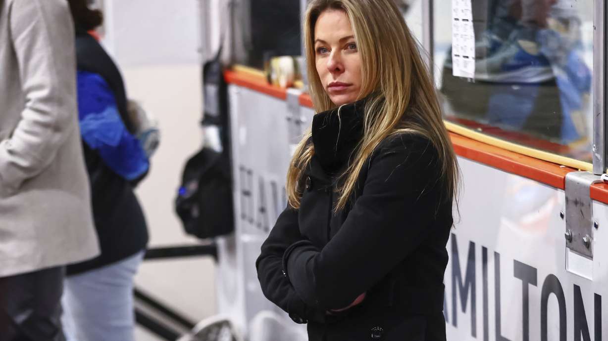 In this image provided by Princeton Athletics, Princeton women's hockey coach Cara Gardner Morey stands at the bench during a hockey game.