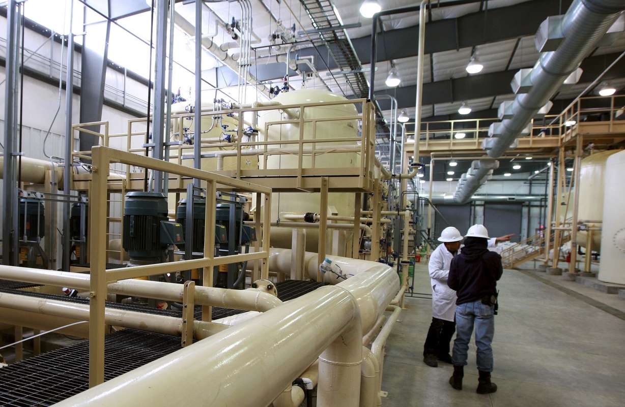 Workers stand inside UR Energy's Lost Creek uranium production facility in Sweetwater County, Wyo, Dec. 9, 2013.
