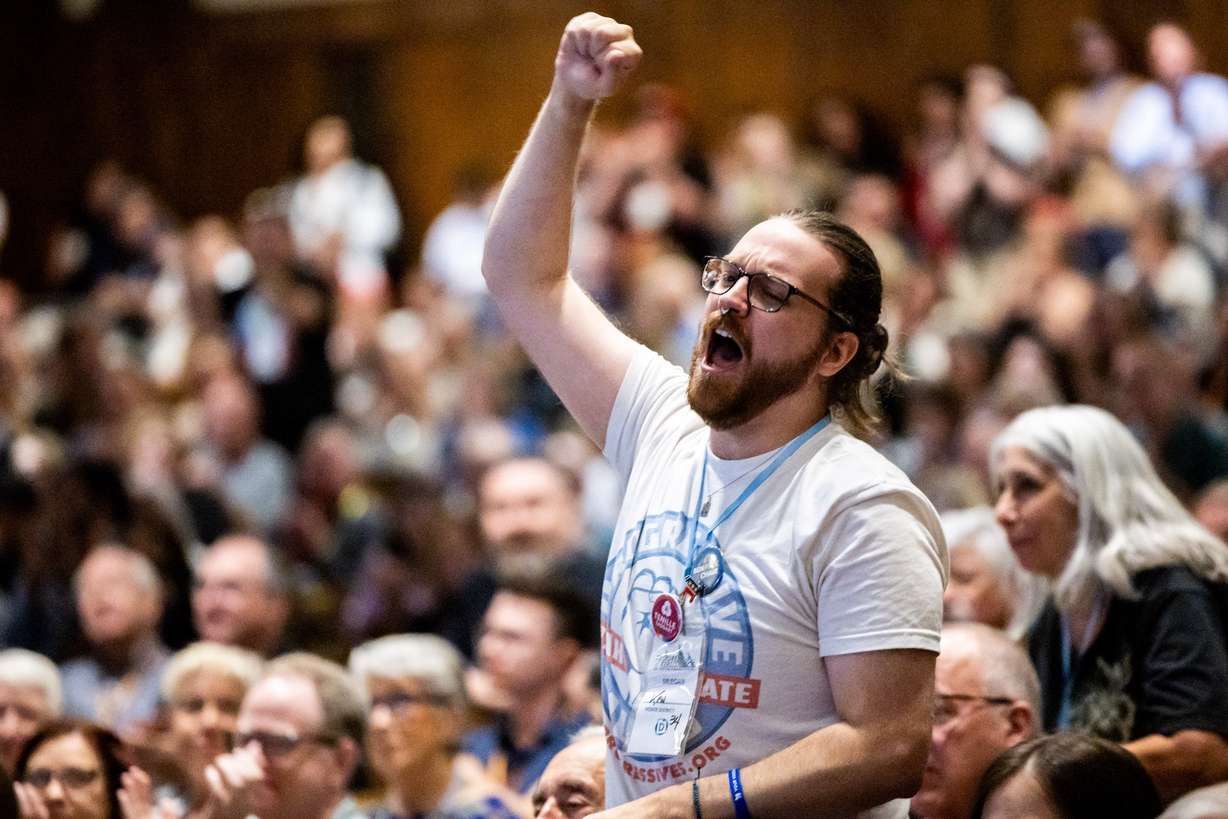 Ken Charette, vice chair of House District 34, cheers for Utah Democratic Party chair candidate Ben Peck at the Utah Democratic Convention at Ogden High School Saturday. Peck was defeated by Brian King.
