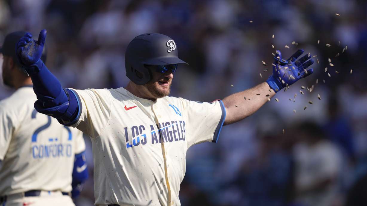 Los Angeles Dodgers' Max Muncy has seeds thrown at him after hitting a three-run home run during the second inning of a baseball game against the New York Yankees, Saturday, May 31, 2025, in Los Angeles.