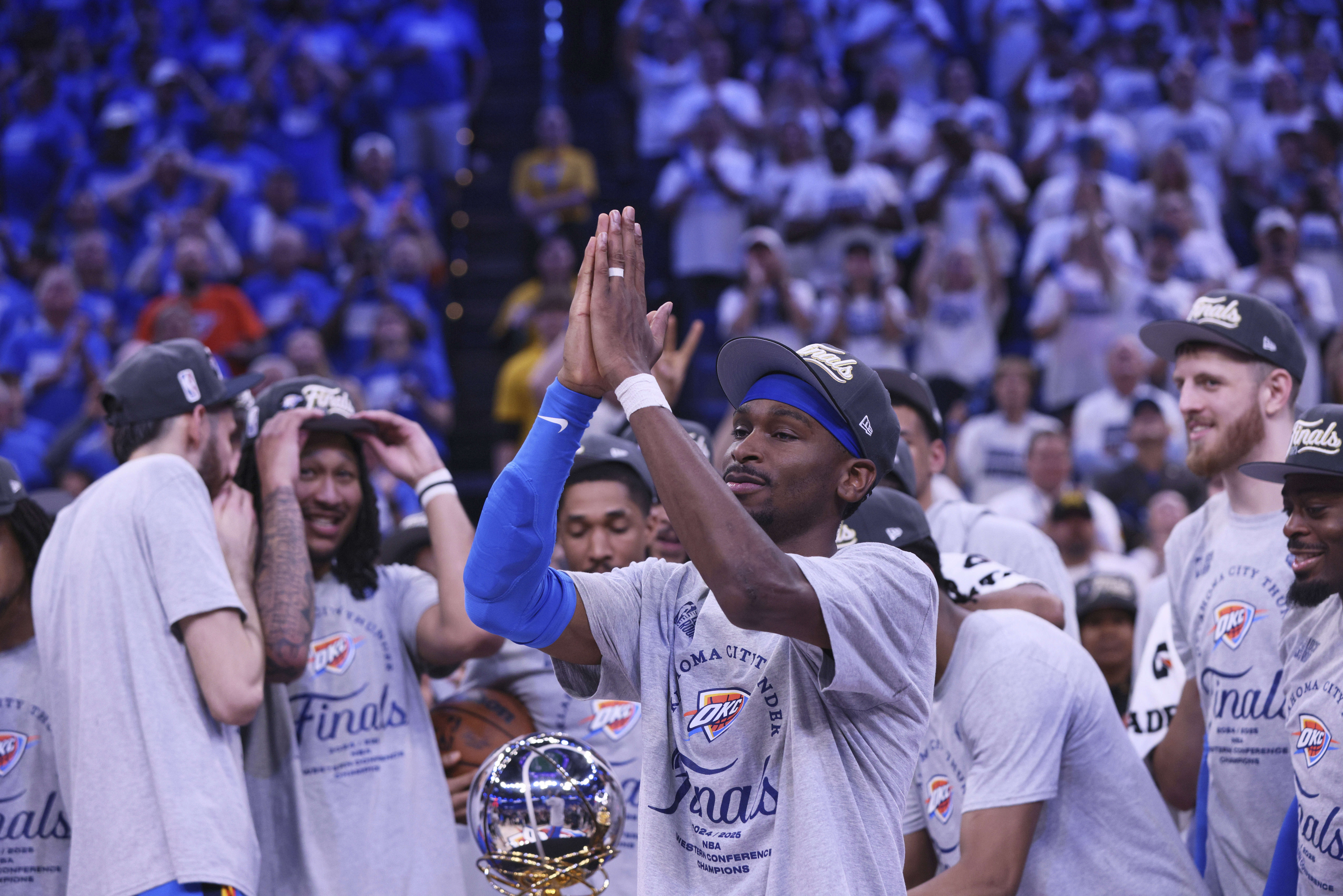 Oklahoma City Thunder guard Shai Gilgeous-Alexander (2), front, celebrates with teammates after Game 5 of the Western Conference finals of the NBA basketball playoffs against the Minnesota Timberwolves, Wednesday, May 28, 2025, in Oklahoma City. 