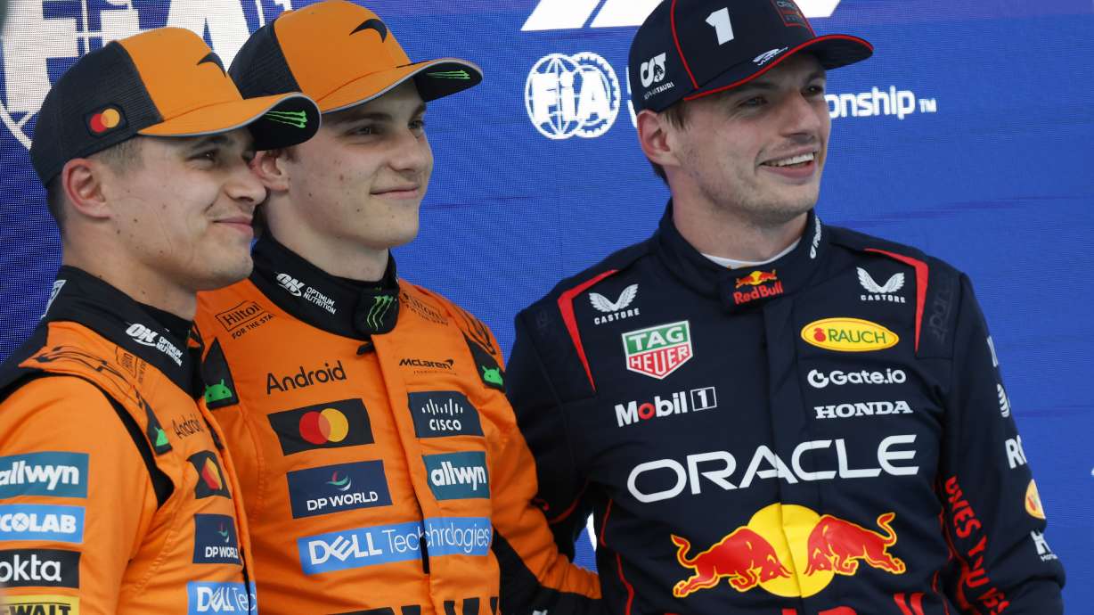 McLaren driver Oscar Piastri of Australia, centre, celebrates his pole position with McLaren driver Lando Norris of Britain, left, and Red Bull driver Max Verstappen of the Netherlands after the qualifying session ahead of the Spanish Grand Prix Formula One race at the Barcelona Catalunya racetrack in Montmelo, near Barcelona, Spain, Saturday, May 31, 2025.