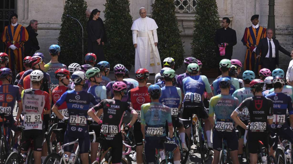 Pope Leo XIV blesses the pack before the official start of the final stage of the Giro d'Italia cycling race inside the Vatican City, Sunday, June 1, 2025.
