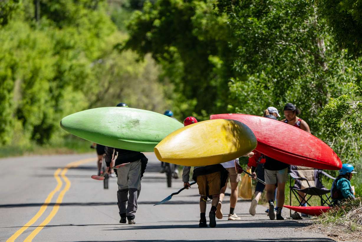 Competitors carry their kayaks to the starting location prior to competing in the Provo River Race, a whitewater kayak competition in Provo Canyon on Saturday.