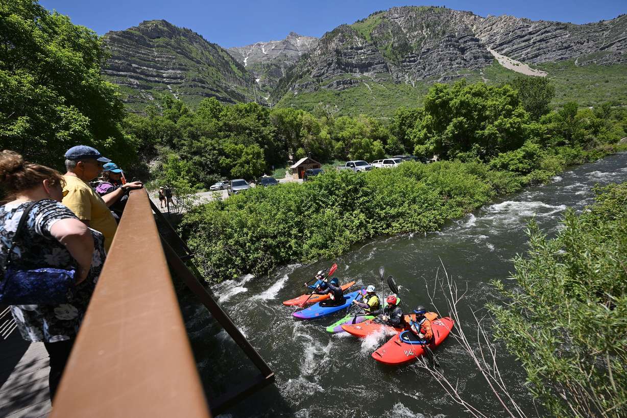 Hikers watch from a bridge as competitors compete in the Provo River Race, a whitewater kayak competition in Provo Canyon on Saturday, May 31, 2025.