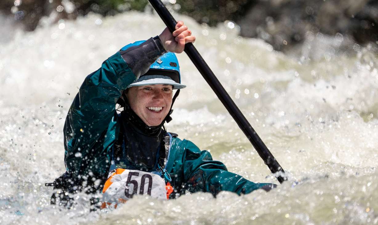 Katie Orr smiles as she hits a low spot in the water as she and other competitors compete in the Provo River Race, a whitewater kayak competition in Provo Canyon on Saturday.