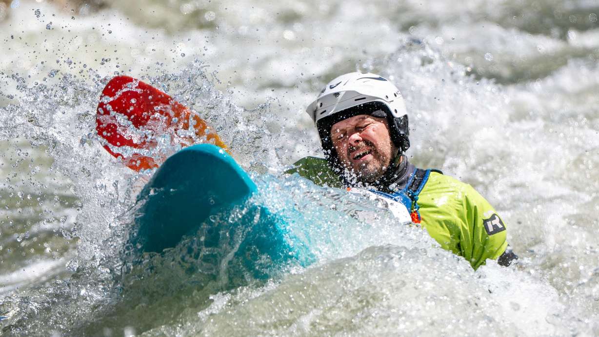 lan Boyer reacts as his kayak plunges into a hole in the water as competitors compete in the Provo River Race, a whitewater kayak competition in Provo Canyon on Saturday.