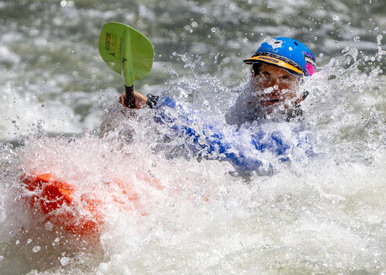 John Asay catches a face full of water as he and other competitors compete in the Provo River Race, a whitewater kayak competition in Provo Canyon on Saturday.