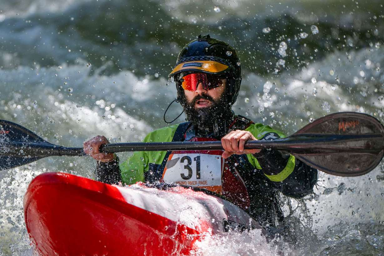 Aaron Reynolds looks for a line as he and other competitors compete in the Provo River Race, a whitewater kayak competition in Provo Canyon on Saturday.