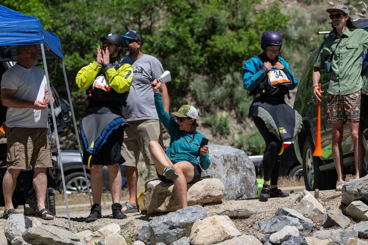 Friends of the racers cheer as the competitors compete in the Provo River Race, a whitewater kayak competition in Provo Canyon on Saturday.