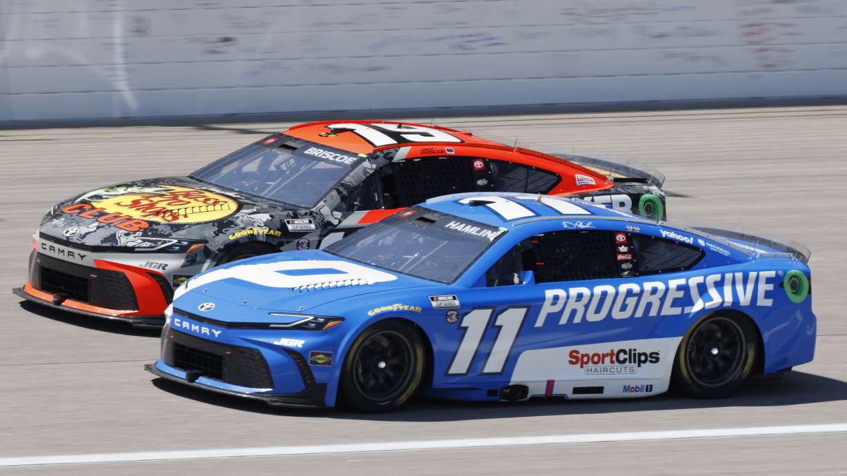 Denny Hamlin (11) and Chase Briscoe (19) head down the front straightaway during a NASCAR Cup Series auto race at Kansas Speedway in Kansas City, Kan., Sunday, May 11, 2025.