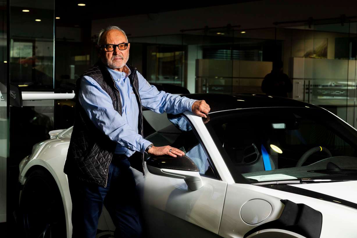 Z.A. Konarski, a 77-year-old native of Poland, who has been selling Porsches for 40-plus years, poses for a portrait with a Porsche 911 GT3 RS on the sales floor of the Porsche dealership in Salt Lake City on May 14. When asked how many cars he has sold, Konarski is quick to clarify: He doesn’t sell cars — he sells Porsches, a brand he has been passionate about since his youth in communist Poland.