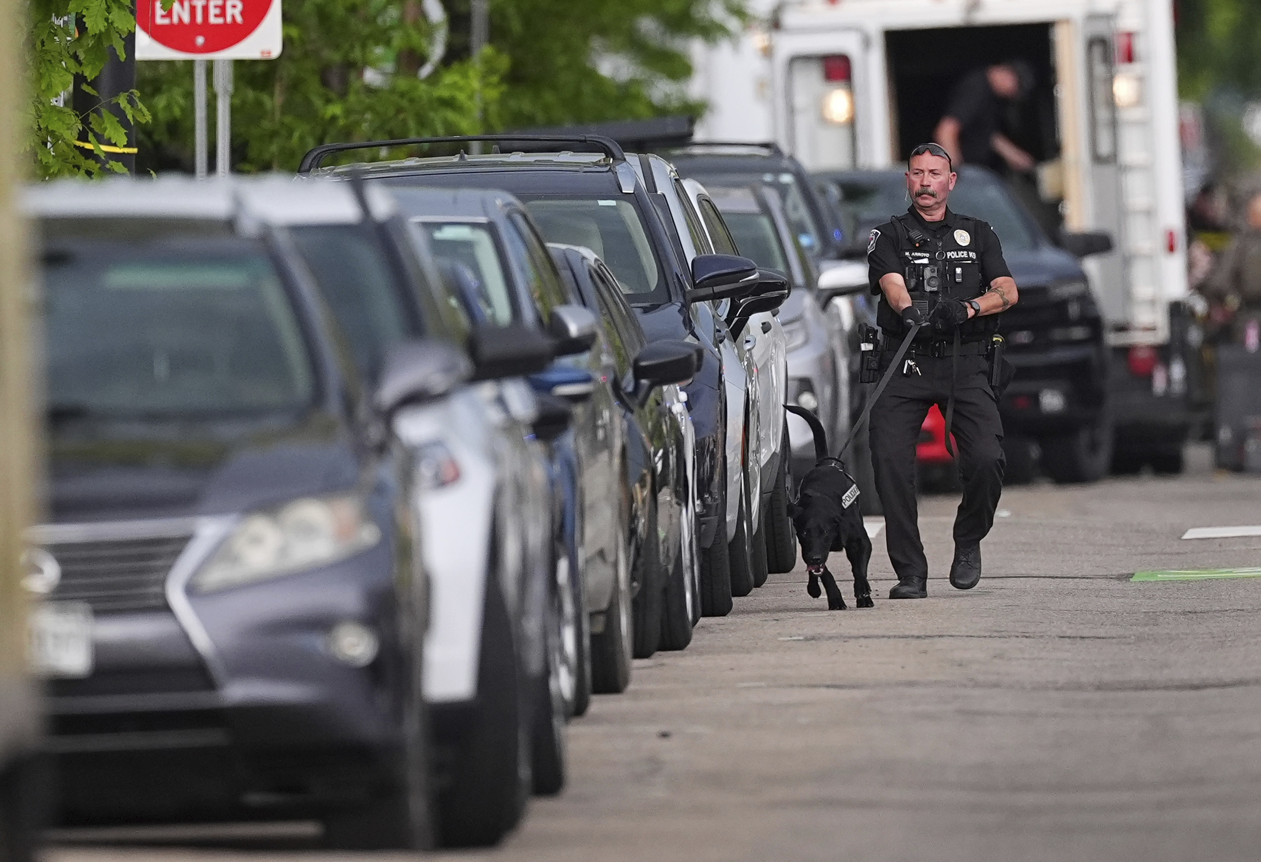 Law enforcement officials investigate after an attack on the Pearl Street Mall Sunday in Boulder, Colo.