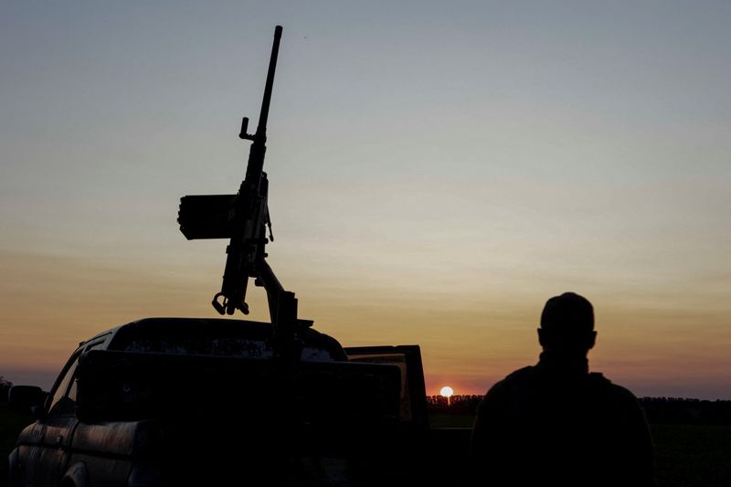 A serviceman from the Ukrainian Armed Forces stands next to a machine gun in Kharkiv Region, Ukraine on Monday. Russia and Ukraine agreed at peace talks on Monday to exchange more prisoners of war and return the bodies of 12,000 dead soldiers.