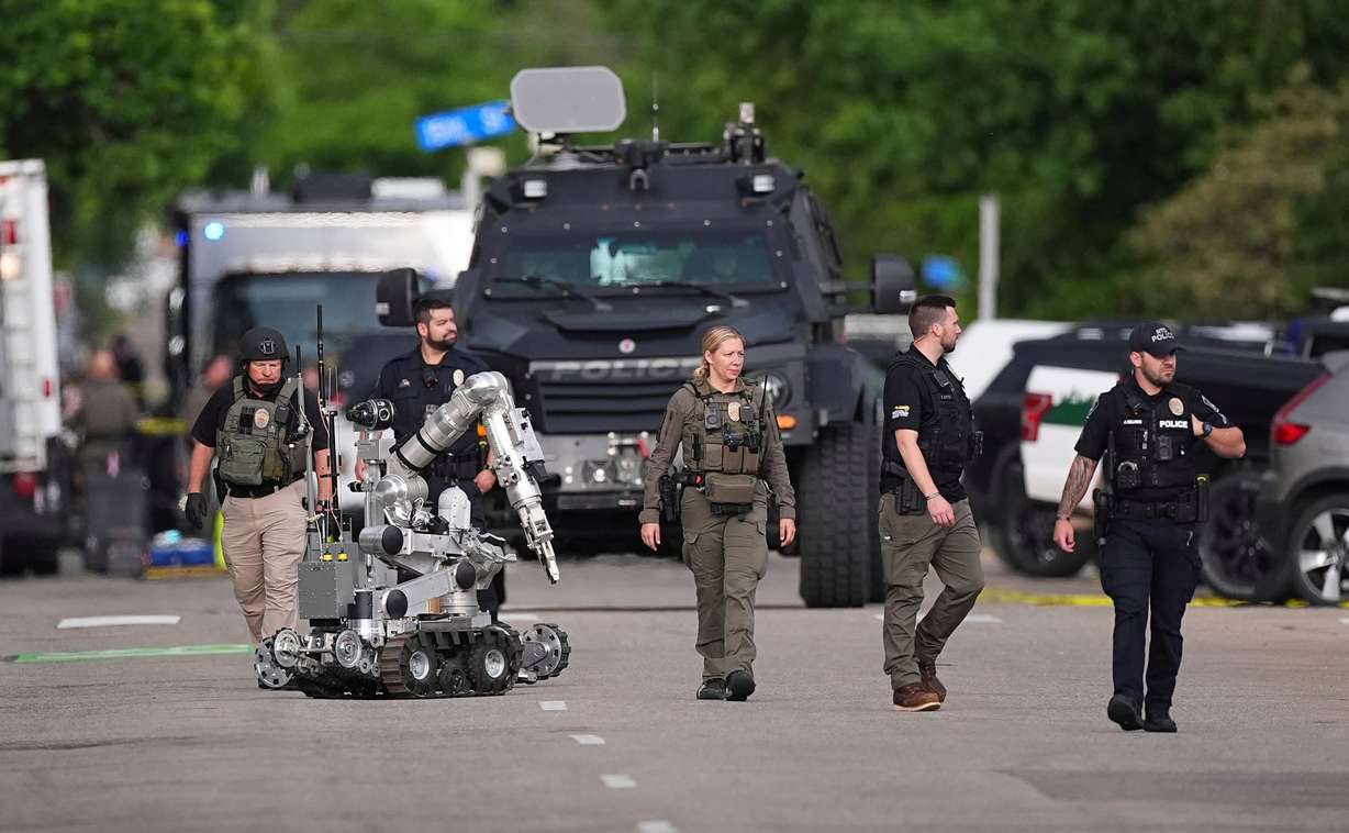 Law enforcement officials investigate after an attack on the Pearl Street Mall, Sunday, in Boulder, Colo.