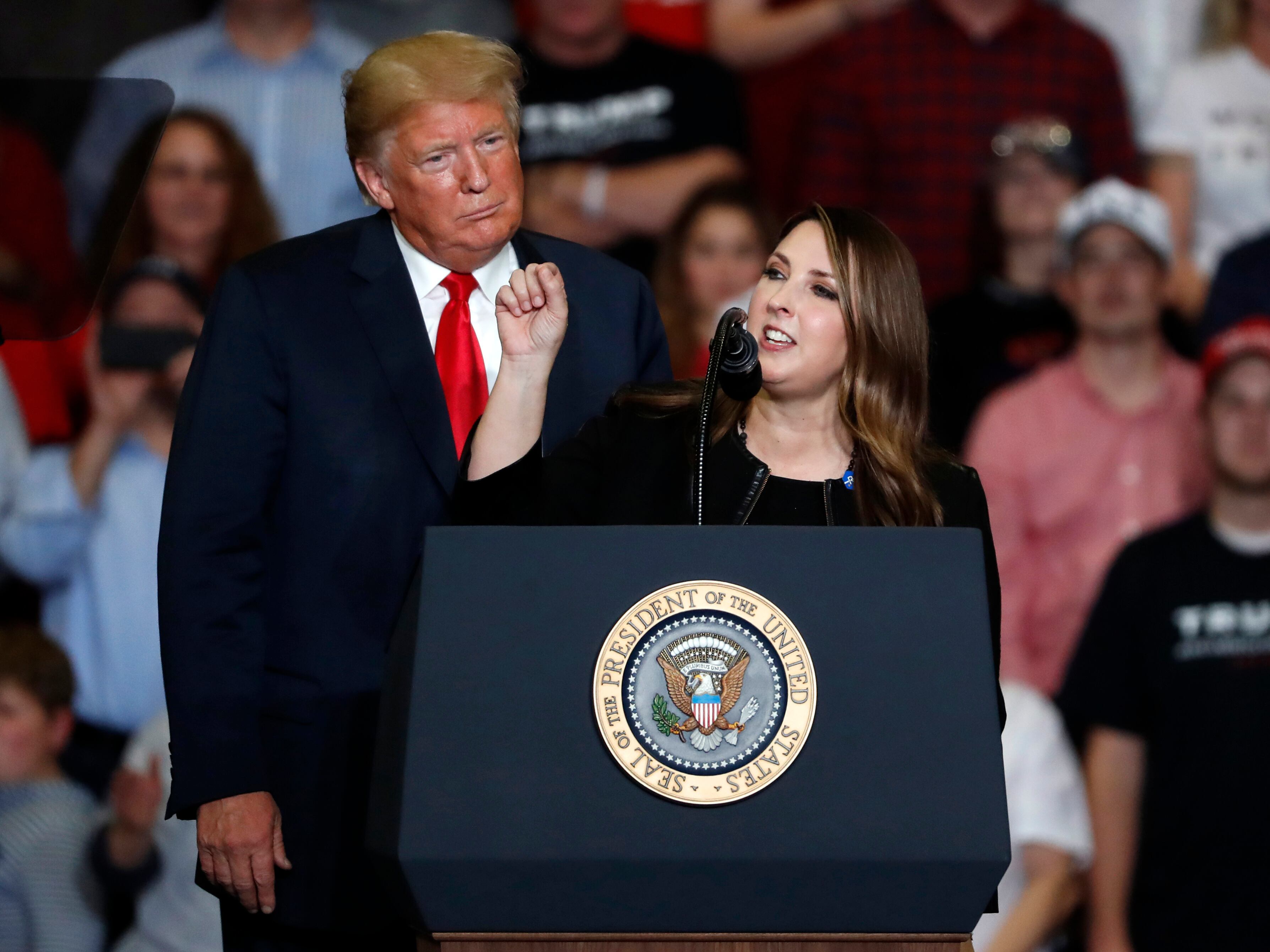 President Donald Trump listens as then-Republican National Committee chair Ronna McDaniel, right, speaks during a campaign rally Nov. 5, 2018, in Cape Girardeau, Mo. McDaniel has been tapped to lead the Michigan Forward Network, a nonprofit organization that is funded by the Devos family.