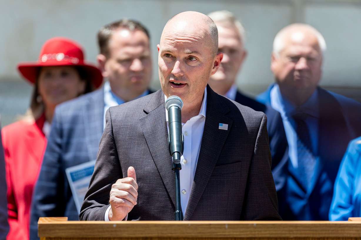 Flanked by mayors of various Utah cities, Utah Gov. Spencer Cox speaks during a press conference as part of a housing summit held at the Governor's Mansion in Salt Lake City on May 29.