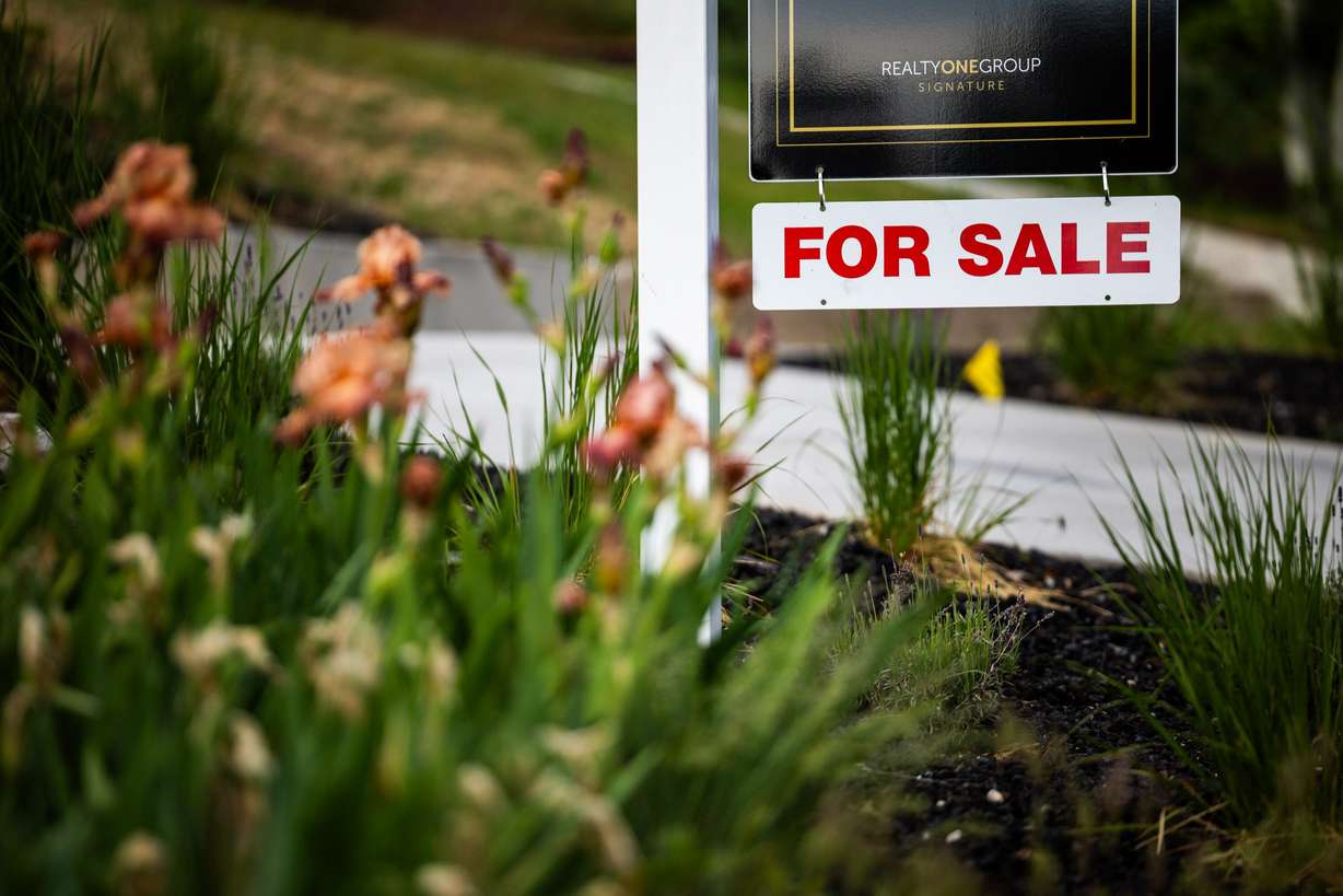 A for-sale sign is posted outside a house in the Avenues neighborhood in Salt Lake City on May 23.