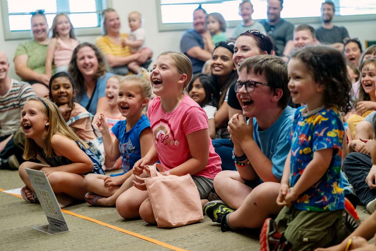 Kids laugh as they are entertained by magician Scott Chamberlain as Taylorsville Library holds its summer reading kickoff party on May 30.