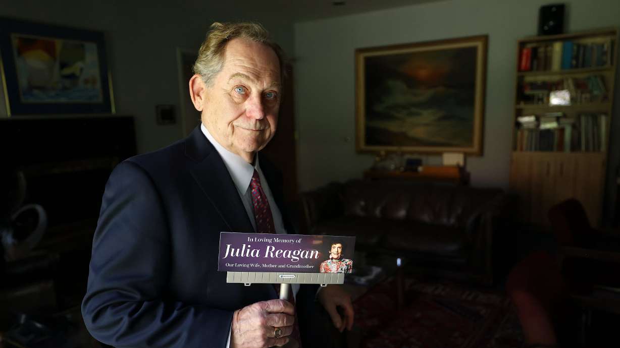 William "Bill" Reagan poses for a portrait with a model of a billboard honoring his late wife, Julia Reagan, at Reagan Outdoor Advertising in Salt Lake City on May 29. He finds comfort in seeing any of the 300 billboards on display honoring Julia Reagan.