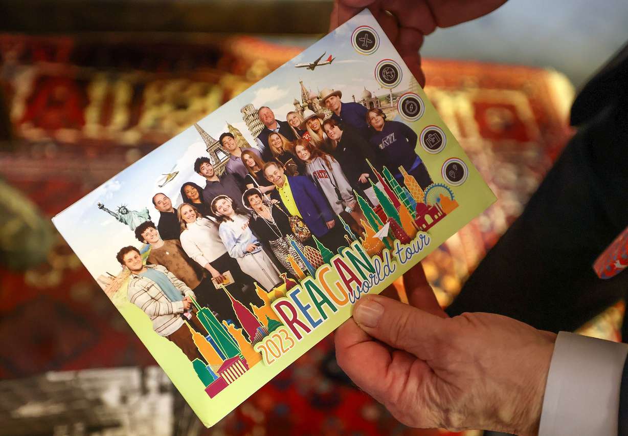 William "Bill" Reagan shows one of his family’s holiday cards while talking about his late wife, Julia Reagan, during an interview in his office at Reagan Outdoor Advertising in Salt Lake City on May 29. He finds comfort in seeing any of the 300 billboards honoring Julia Regan across Utah and beyond.