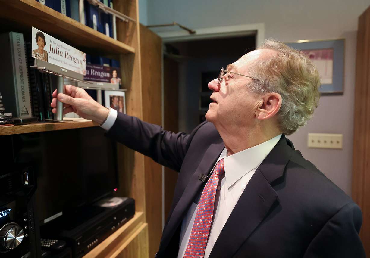 William "Bill" Reagan shows various models of billboards honoring his late wife, Julia Reagan, at Reagan Outdoor Advertising in Salt Lake City on May 29. He finds comfort in seeing any of the 300 billboards on display honoring Julia Reagan in Utah and beyond.