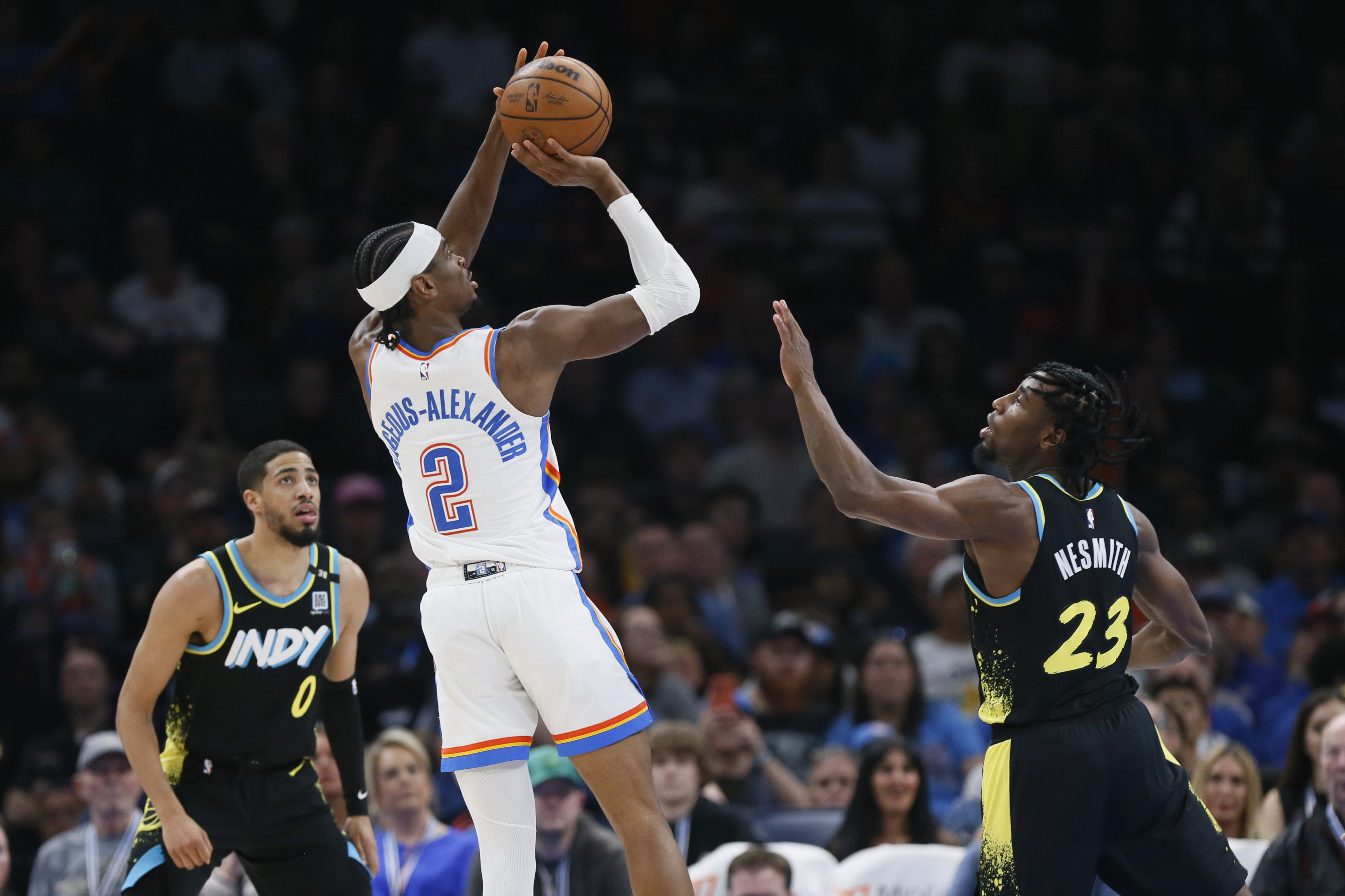 FILE - Oklahoma City Thunder guard Shai Gilgeous-Alexander (2) looks to shoot between Indiana Pacers guard Tyrese Haliburton (0) and forward Aaron Nesmith (23) during the second half of an NBA basketball game Tuesday, March 12, 2024, in Oklahoma City.