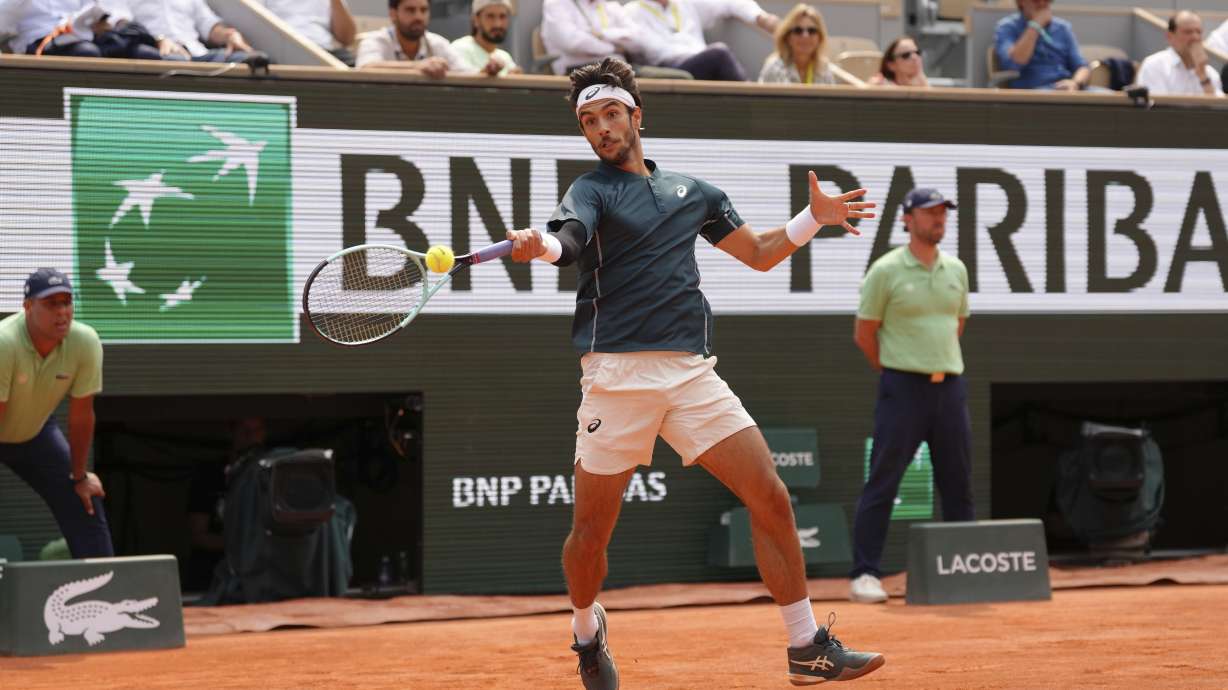 Italy's Lorenzo Musetti plays a shot against Frances Tiafoe of the U.S. during their quarterfinal match of the French Tennis Open at the Roland-Garros stadium in Paris, Tuesday, June 3, 2025.