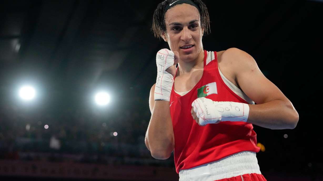 Algeria's Imane Khelif poses after defeating China's Yang Liu to win gold in their women's 66 kg final boxing match at the 2024 Summer Olympics, Friday, Aug. 9, 2024, in Paris, France.
