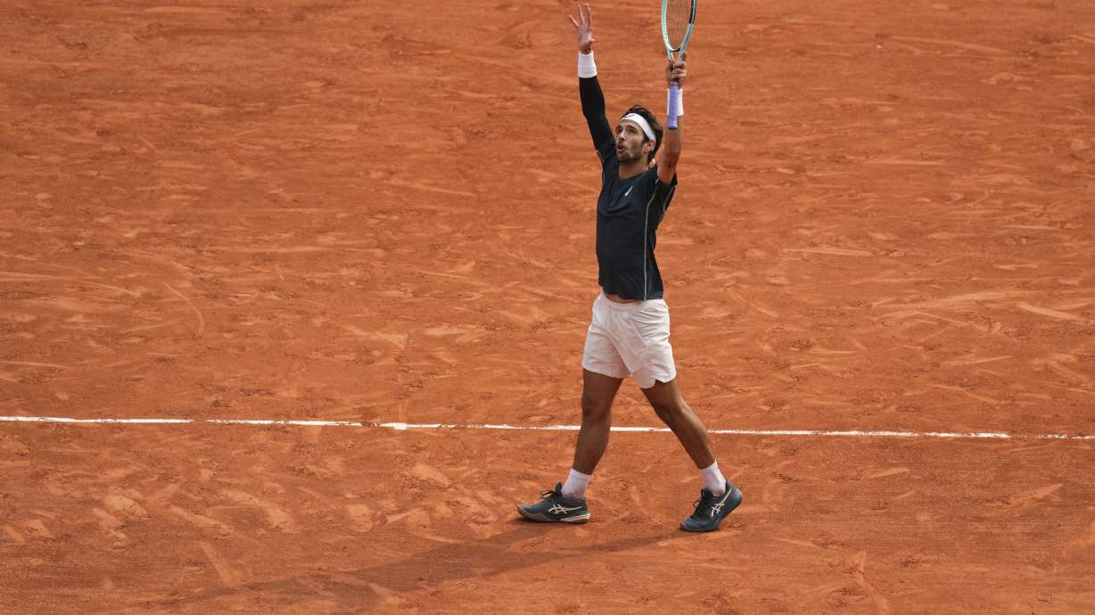 Italy's Lorenzo Musetti reacts as he plays against Frances Tiafoe of the U.S. during their quarterfinal match of the French Tennis Open at the Roland-Garros stadium in Paris, Tuesday, June 3, 2025.