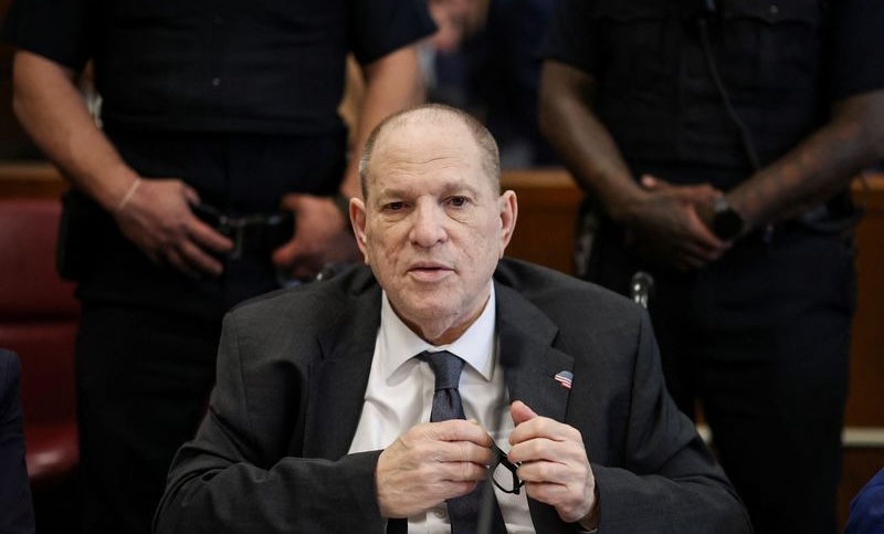 Former Hollywood film producer Harvey Weinstein appears in Manhattan Criminal Court for his retrial on rape and sexual assault charges in New York City, Tuesday. A prosecutor told a jury Tuesday Weinstein used his influence to abuse women.