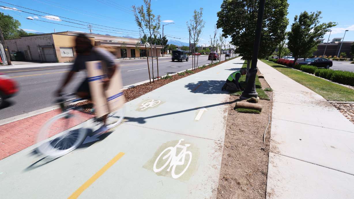 A cyclist uses the new bike lanes along 300 West between 900 South and 2100 South on July 28, 2023. A state study of recent Salt Lake road projects released Wednesday found little impact to this point, but the city plans to make adjustments.