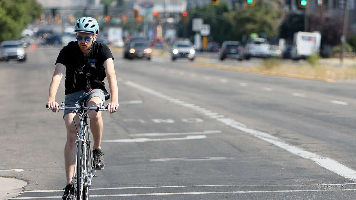 A cyclist on 300 West on July 17, 2024. The Utah Department of Transportation launched a survey last week that seeks feedback on recent transportation projects in the city.