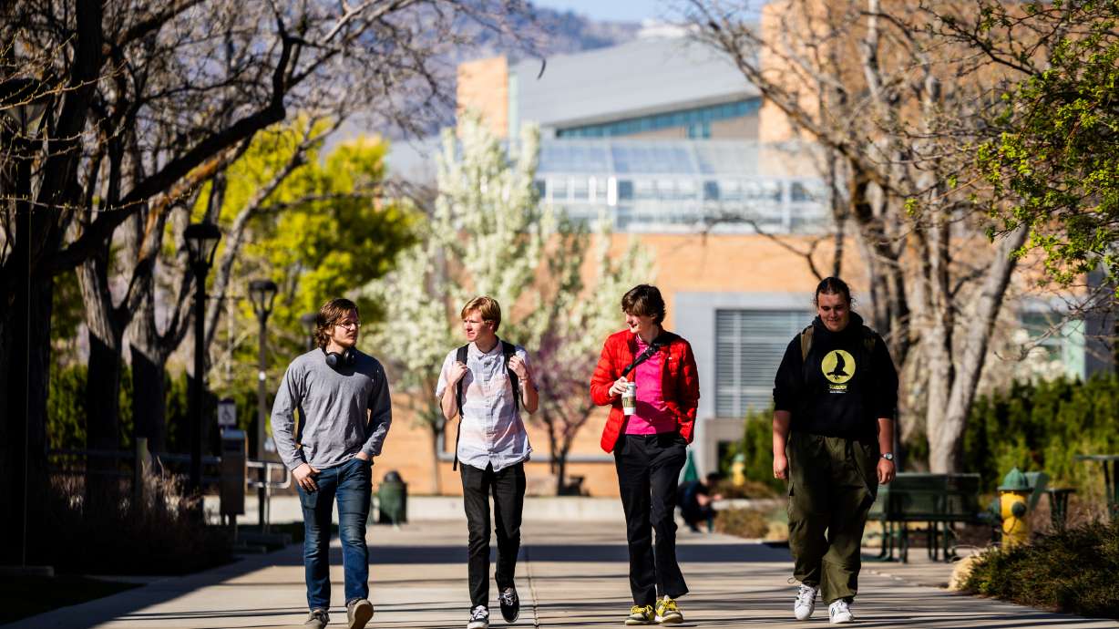 Students Aiden Morton, Cooper Hatsis, Graff Linnebach, and Adam Enslow, from left, walk at Weber State University April 14. A report says students at Utah's postsecondary institutions received federal student aid awards totaling $1.6 billion in the 2022-23 school year.