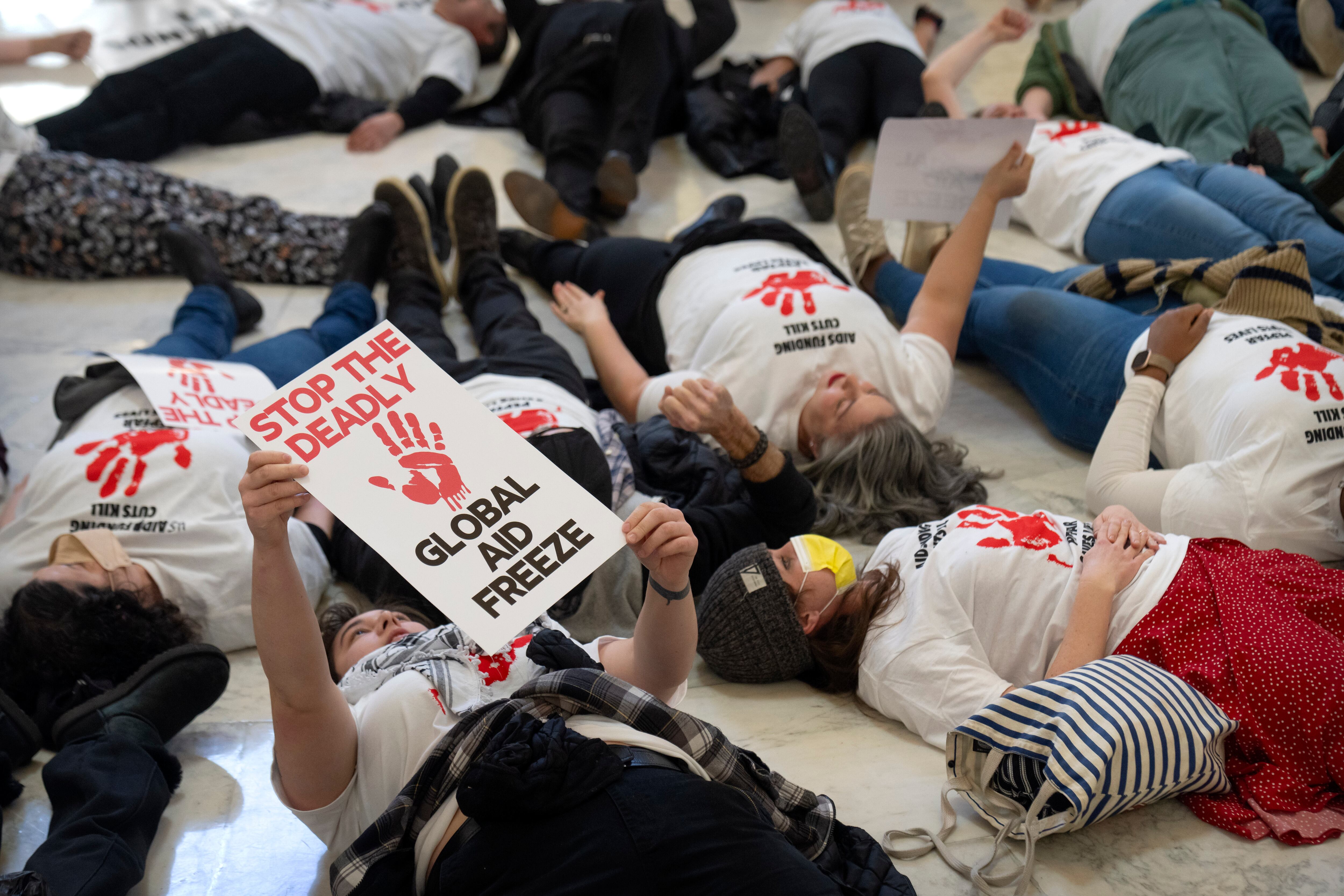 Demonstrators protest against cuts to American foreign aid spending, including USAID and a program to combat HIV/AIDS, at the Cannon House Office Building on Capitol Hill, Feb. 26 in Washington.