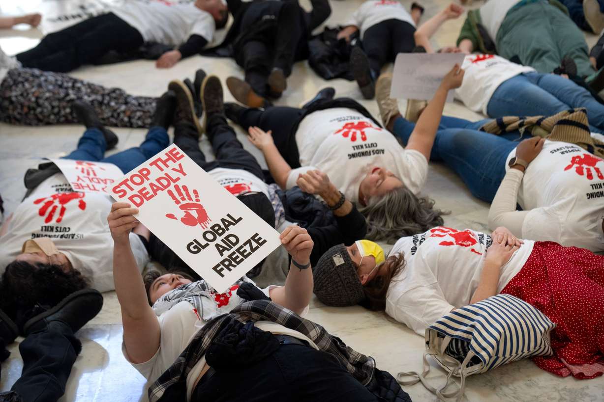 Demonstrators protest against cuts to American foreign aid spending, including USAID and a program to combat HIV/AIDS, at the Cannon House Office Building on Capitol Hill, Feb. 26 in Washington.