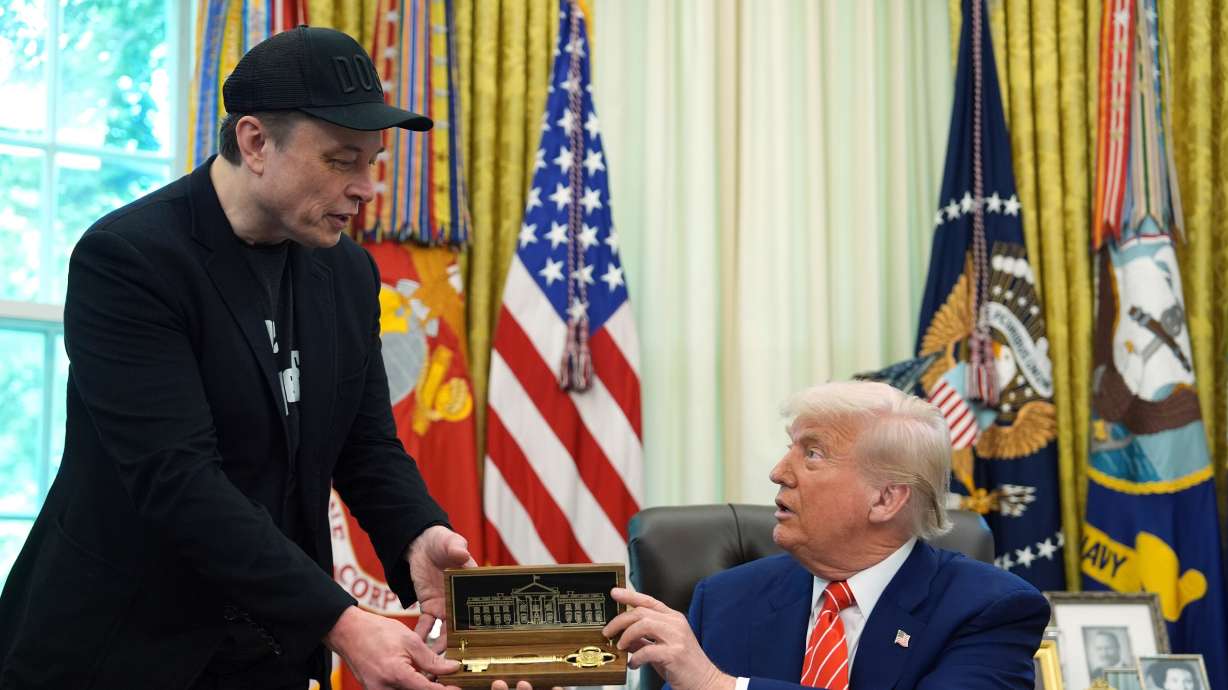 President Donald Trump, right, presents a key to Elon Musk in the Oval Office of the White House, May 30 in Washington. Top Republicans are brushing off criticism by Musk, who decried Trump's massive tax package.