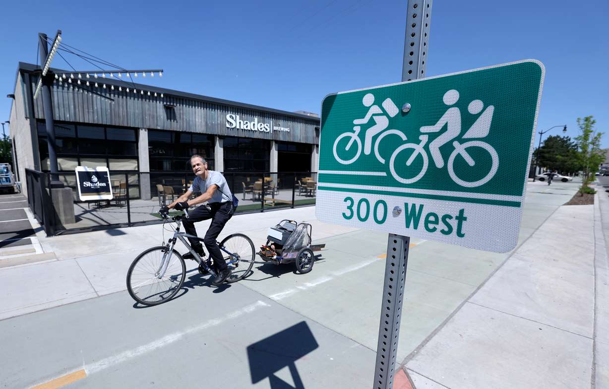A cyclist bikes on the 300 West bikeway in Salt Lake City on Tuesday.