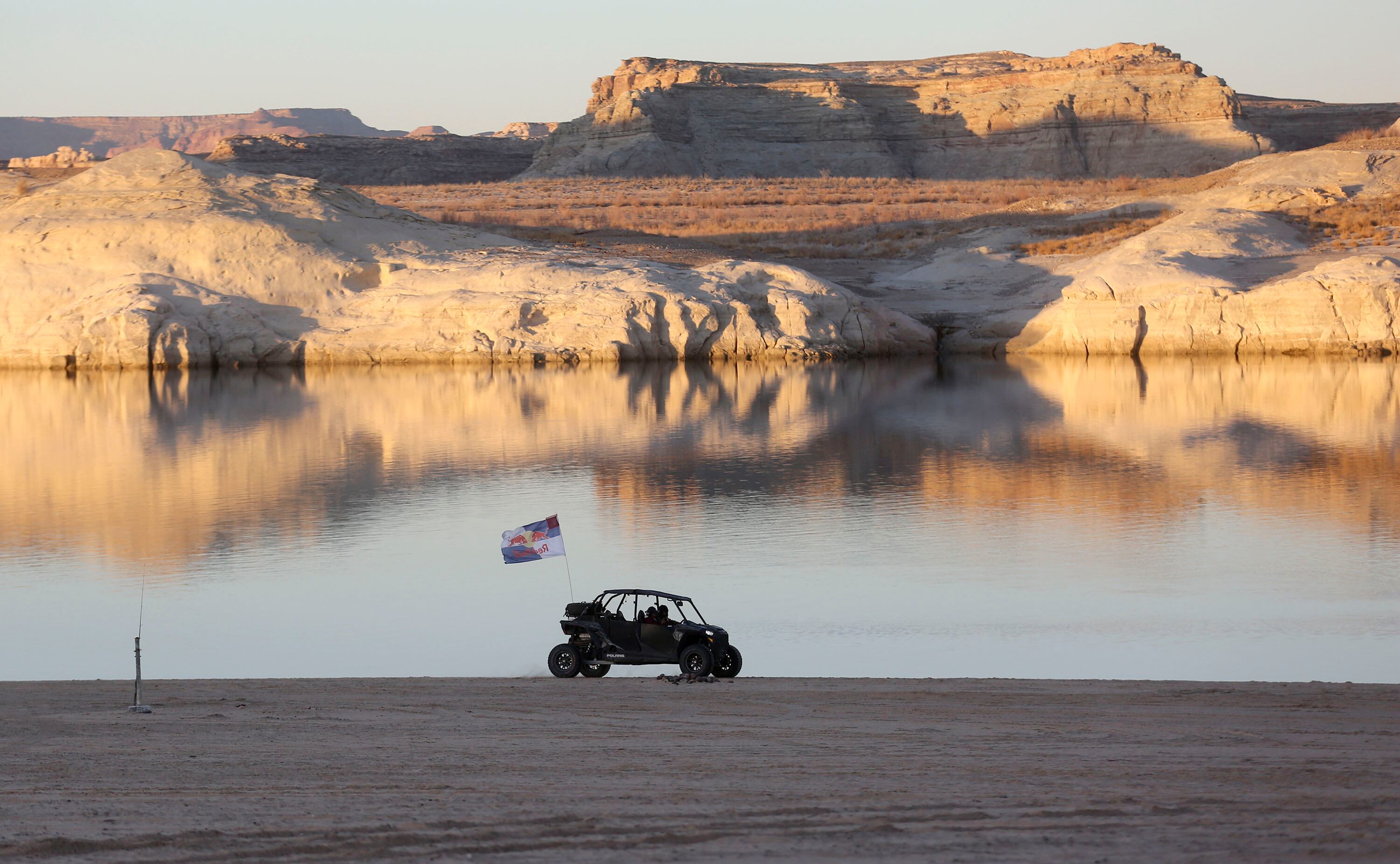 A RZR at Lone Rock Beach in the Glen Canyon National Recreation Area in Utah on March 27, 2021. The reservoir is back down to 25% full, and a new outlook released on Friday says it's on track for its fifth-worst snowpack runoff on record.