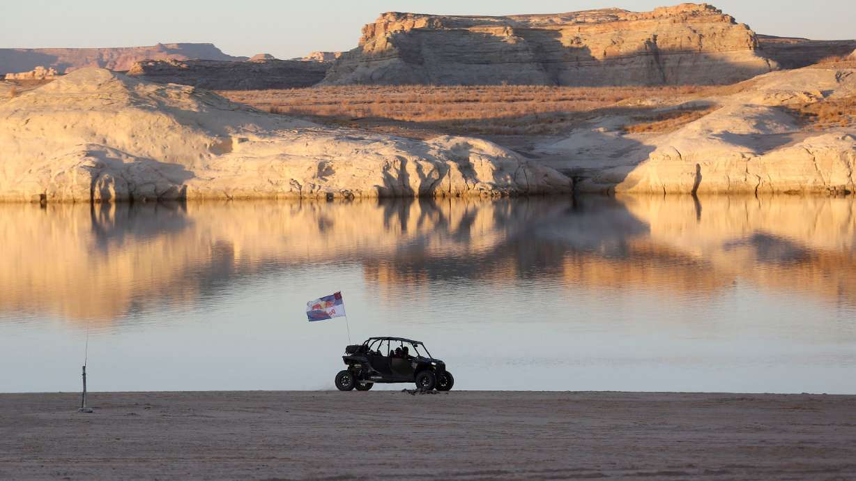 A RZR at Lone Rock Beach in the Glen Canyon National Recreation Area in Utah on March 27, 2021. The reservoir is back down to 25% full, and a new outlook released on Friday says it's on track for its fifth-worst snowpack runoff on record.