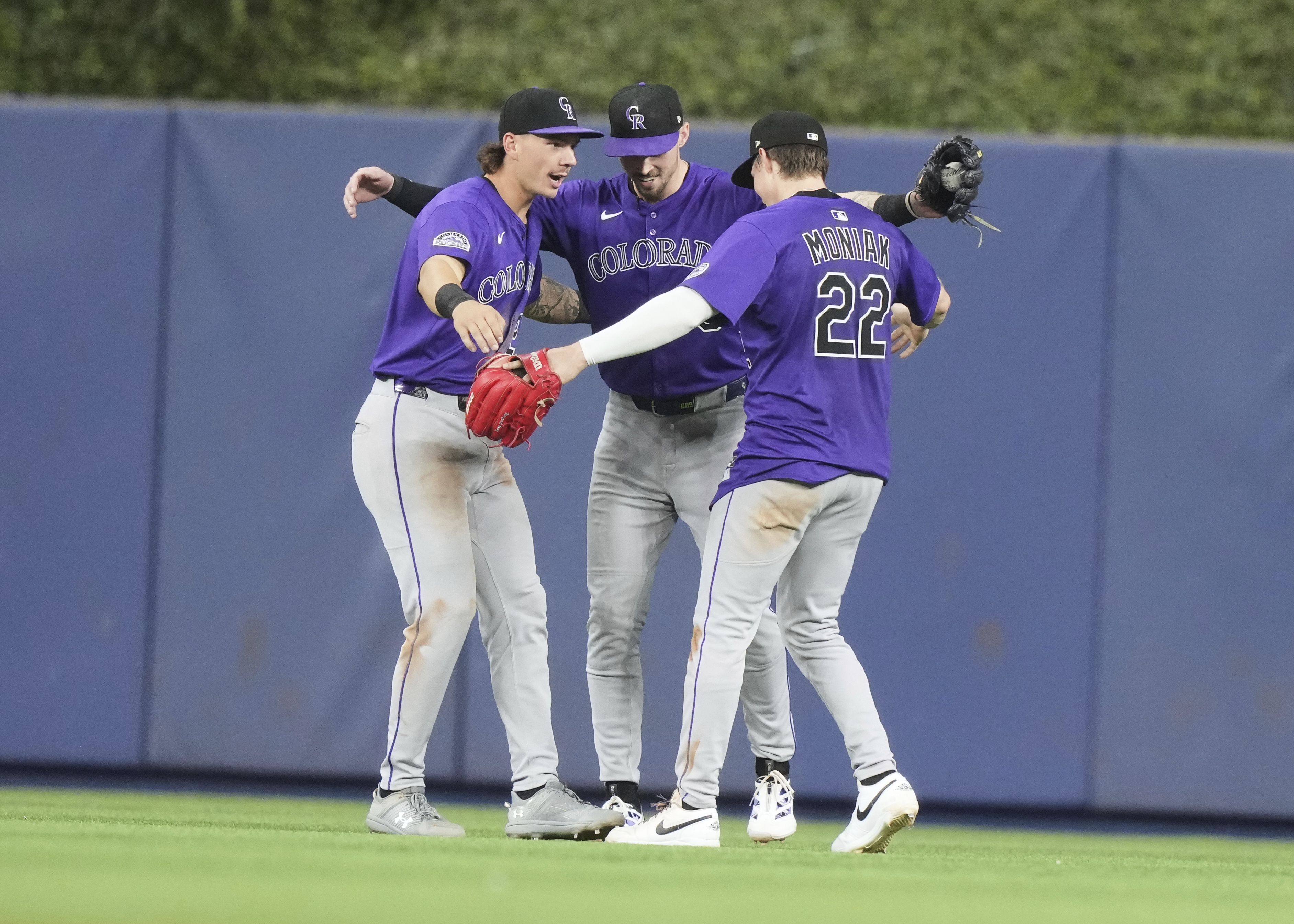 Colorado Rockies left fielder Jordan Beck, left, center fielder Brenton Doyle, center and right fielder Mickey Moniak (22) celebrate after the Rockies defeated the Miami Marlins in a baseball game, Tuesday, June 3, 2025, in Miami. 