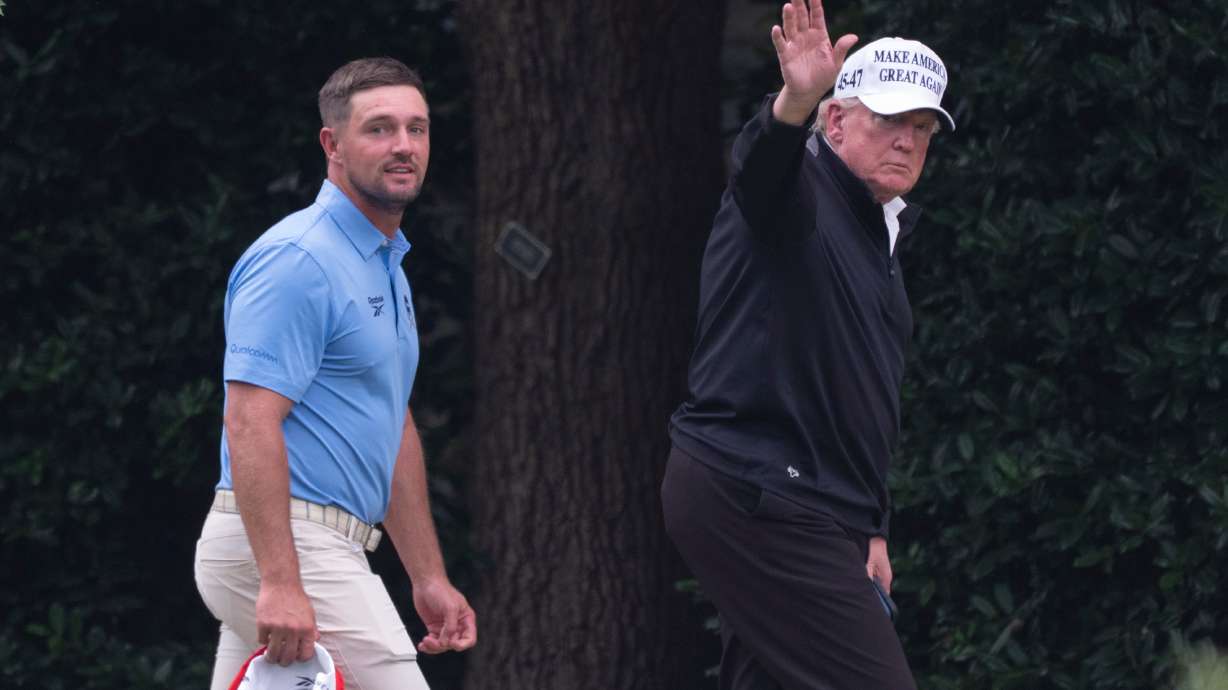 President Donald Trump, right, walks toward the Oval Office as he returns to the White House with Bryson DeChambeau, winner of the 2024 U.S. Open, after playing golf, Sunday, June 1, 2025.