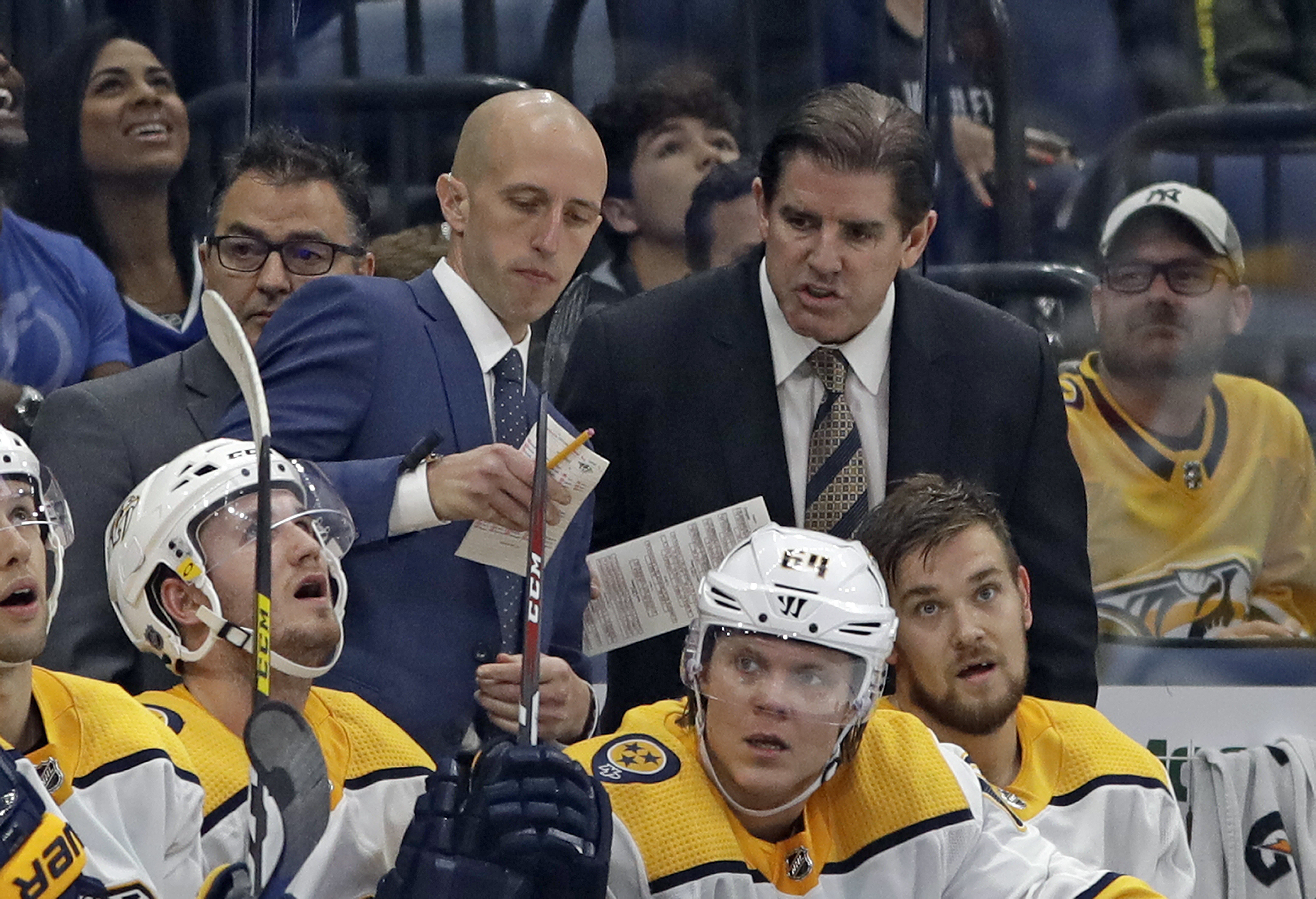 FILE - Nashville Predators head coach Peter Laviolette, right, and assistant coach Dan Muse during the third period of an NHL hockey game against the Tampa Bay Lightning, Oct. 26, 2019, in Tampa, Fla. 