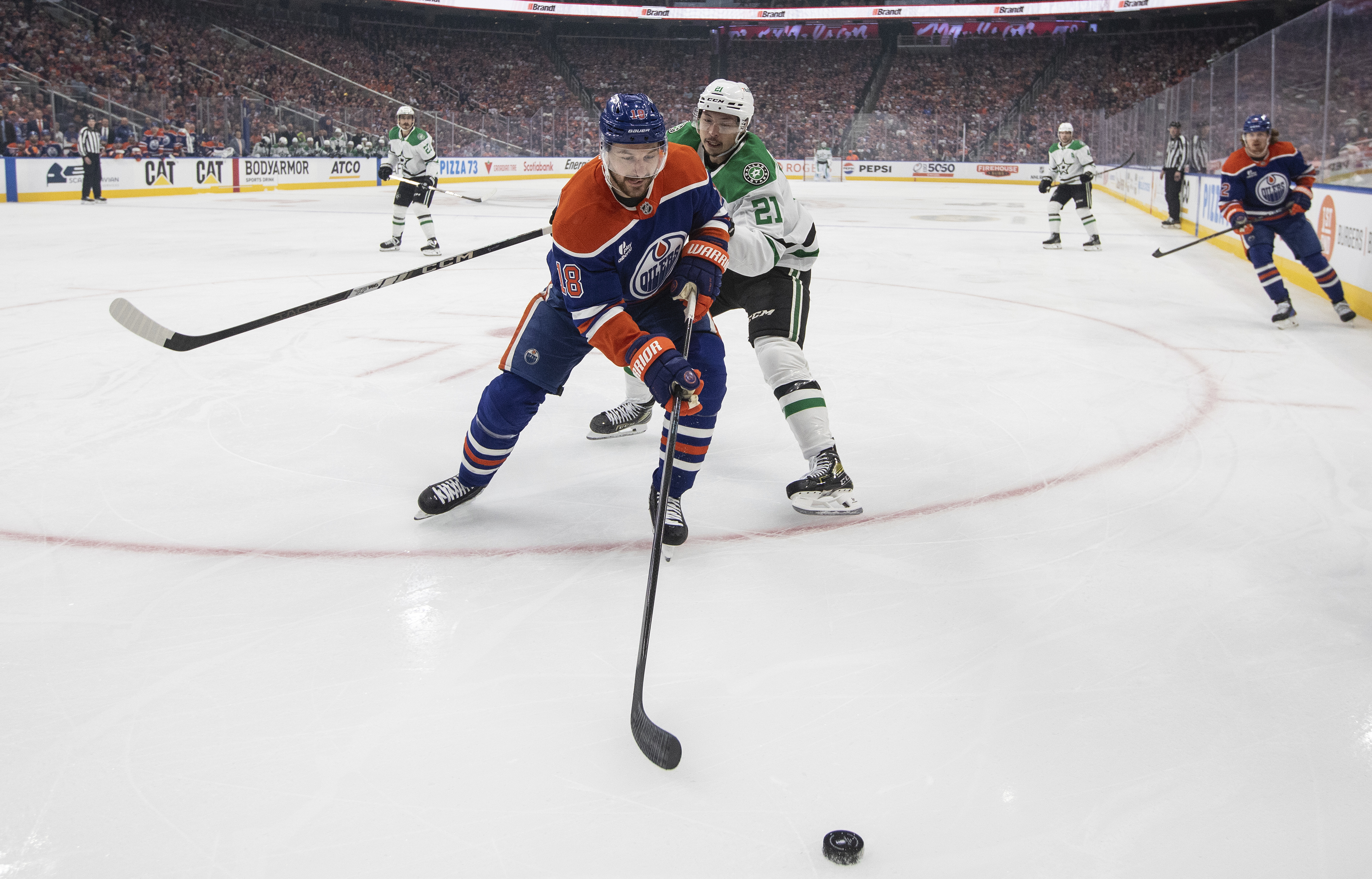 Dallas Stars' Jason Robertson (21) and Edmonton Oilers' Zach Hyman (18) battle for the puck during first period NHL Western Conference final playoff action, in Edmonton on Tuesday, May 27, 2025. 