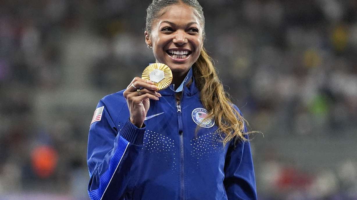 FILE - Gold medalist Gabby Thomas stands on the podium after the women's 200-meter at the 2024 Summer Olympics, Wednesday, Aug. 7, 2024, in Saint-Denis, France.