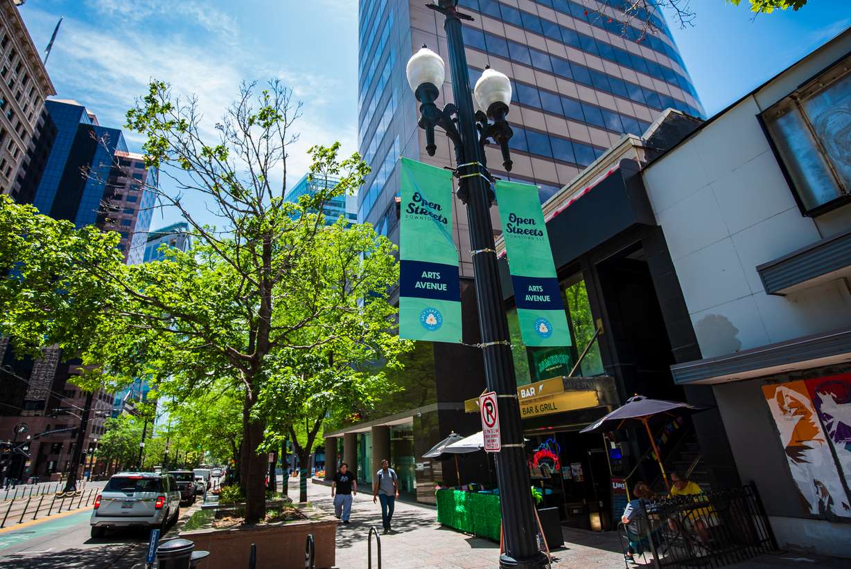 Signs promoting Open Streets hang from light poles along Main Street in downtown Salt Lake City on Wednesday.