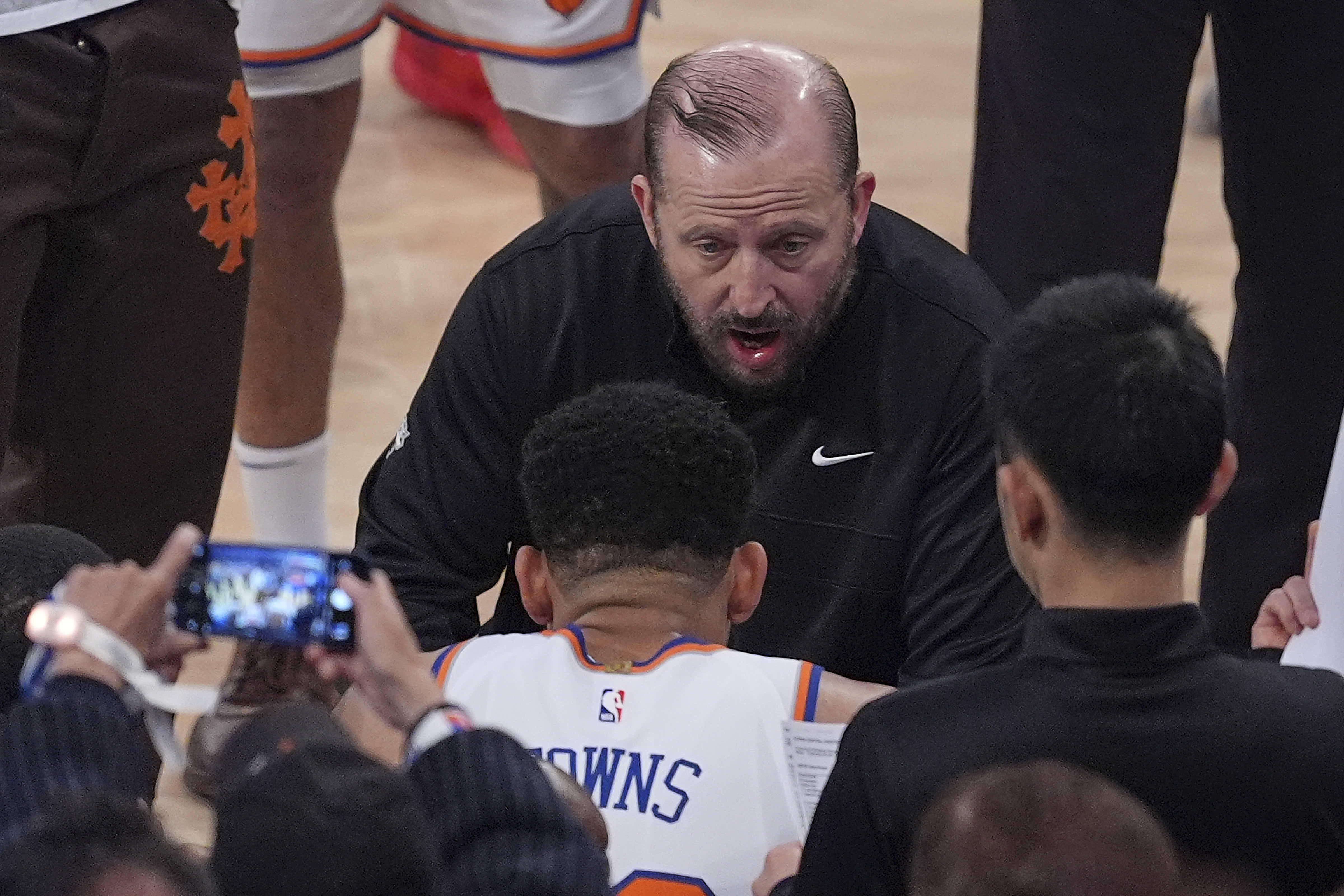 New York Knicks head coach Tom Thibodeau talks with players during a break in play against the Indiana Pacers during the first quarter of Game 5 of the NBA basketball Eastern Conference final, Thursday, May 29, 2025, in New York. 
