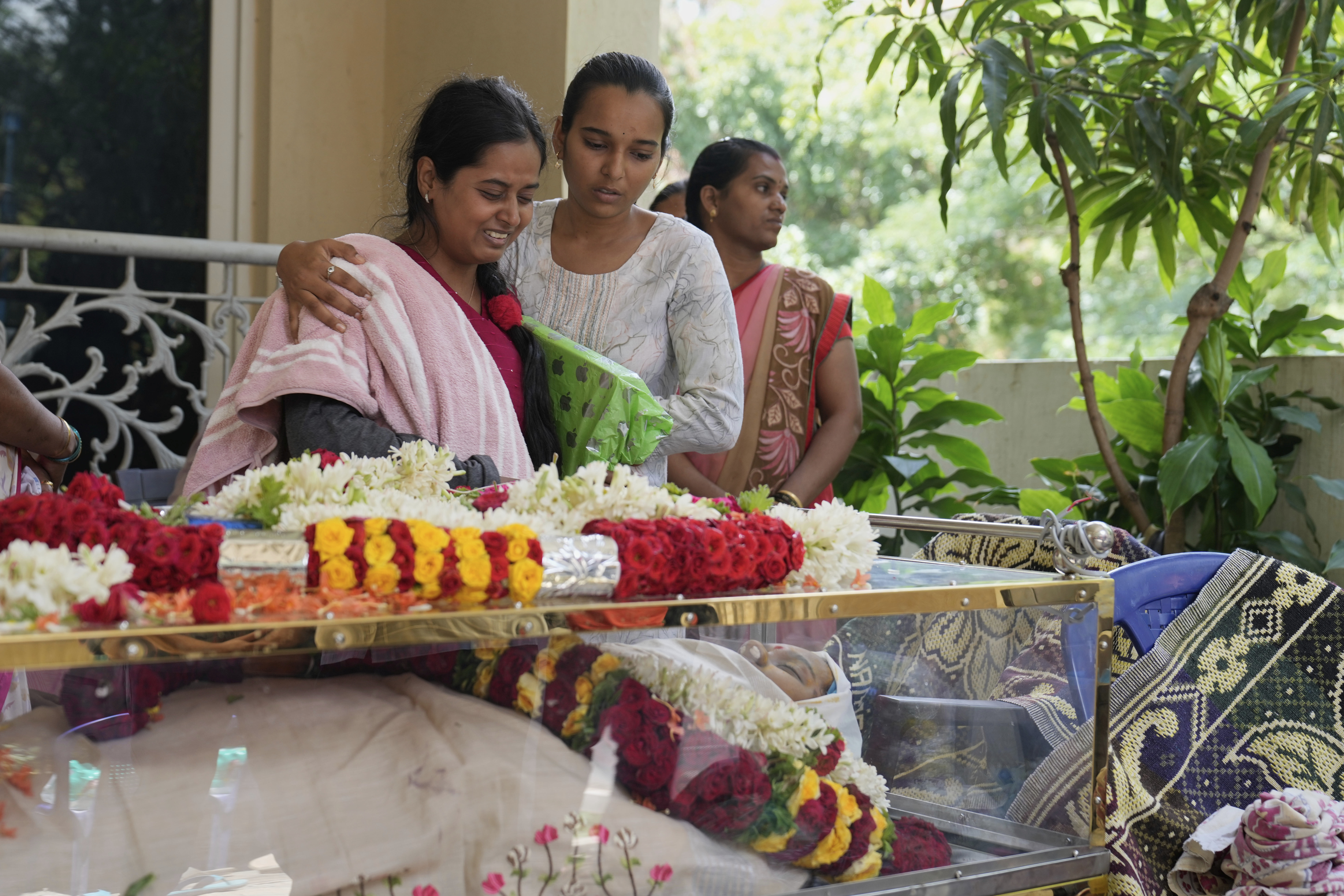 A relative cries next to the body of 14-year-old Divyanshi Shivakumar, who lost her life in Wednesday's deadly stampede during celebrations outside a stadium for Royal Challengers Bengaluru, winners of the Indian Premier League, at her residence ahead of her last rites in Bengaluru, India, Thursday, June 5, 2025. 