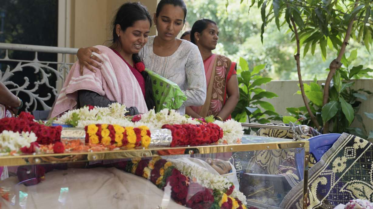 A relative cries next to the body of 14-year-old Divyanshi Shivakumar, who lost her life in Wednesday's deadly stampede during celebrations outside a stadium for Royal Challengers Bengaluru, winners of the Indian Premier League, at her residence ahead of her last rites in Bengaluru, India, Thursday, June 5, 2025.